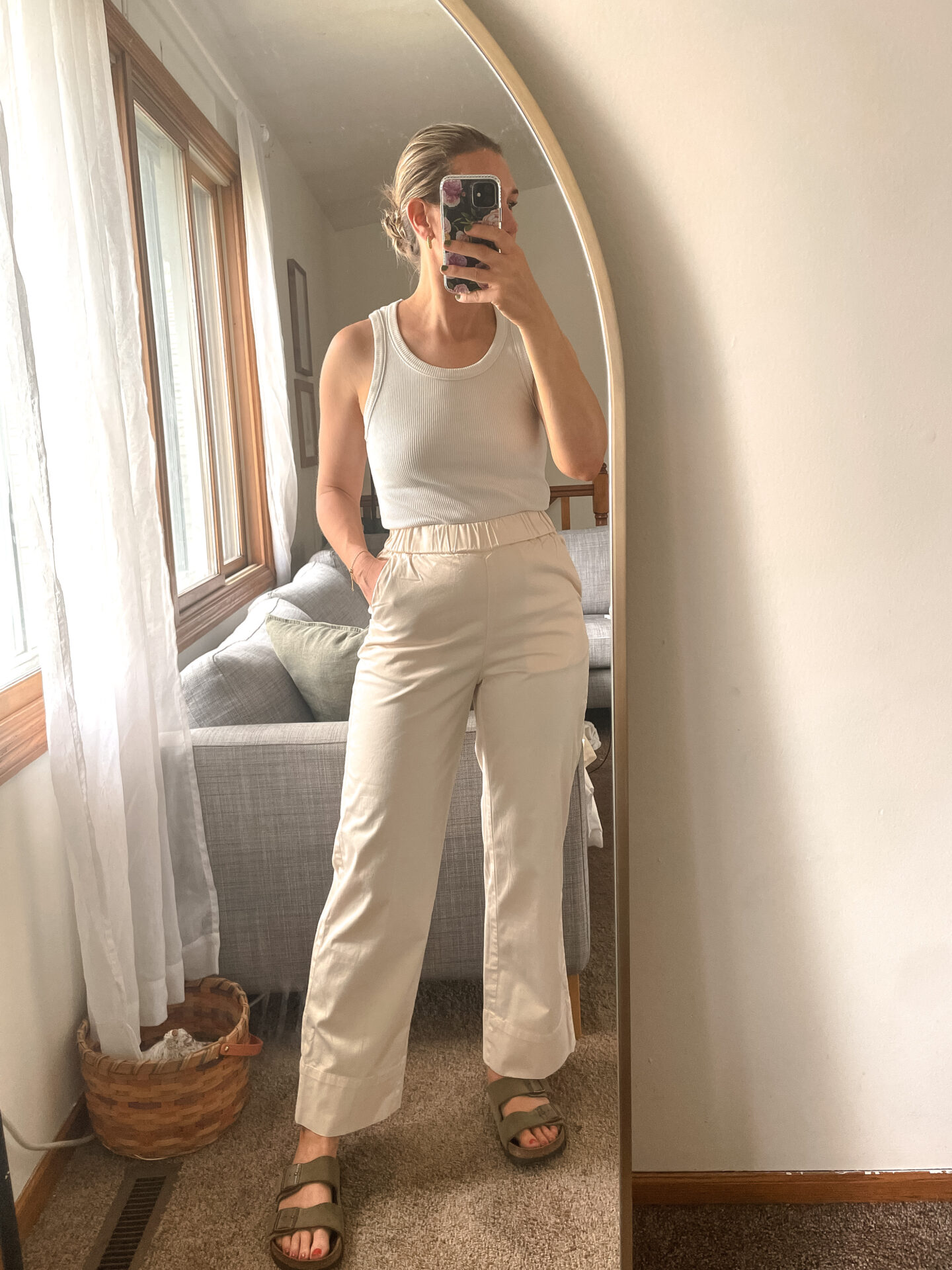 Karin Emily wears a pair of Everlane Pants with a white tank and birkenstock arizona sandals