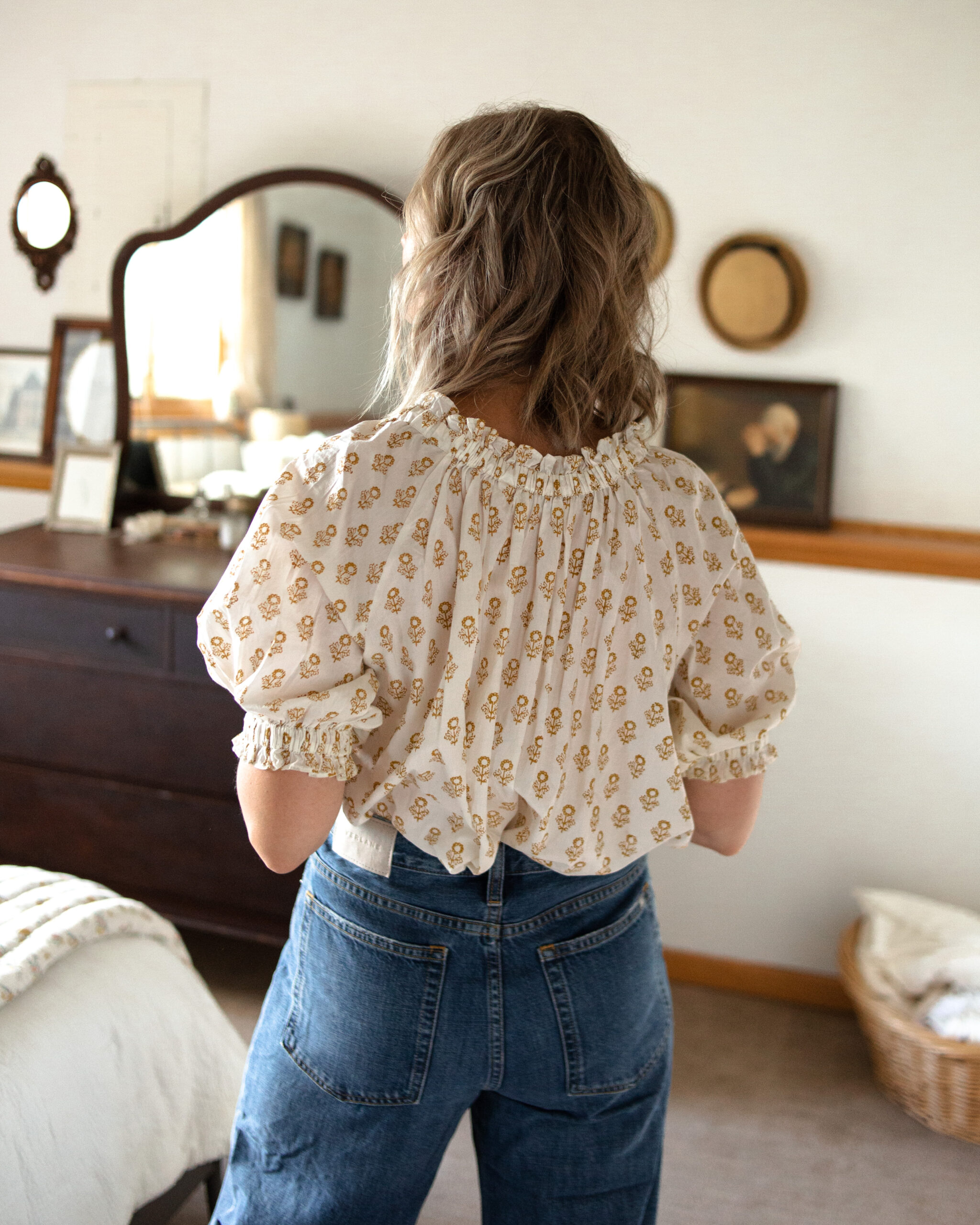 Karin Emily is wearing the Baggy Jean from Everlane with a Doen floral blouse