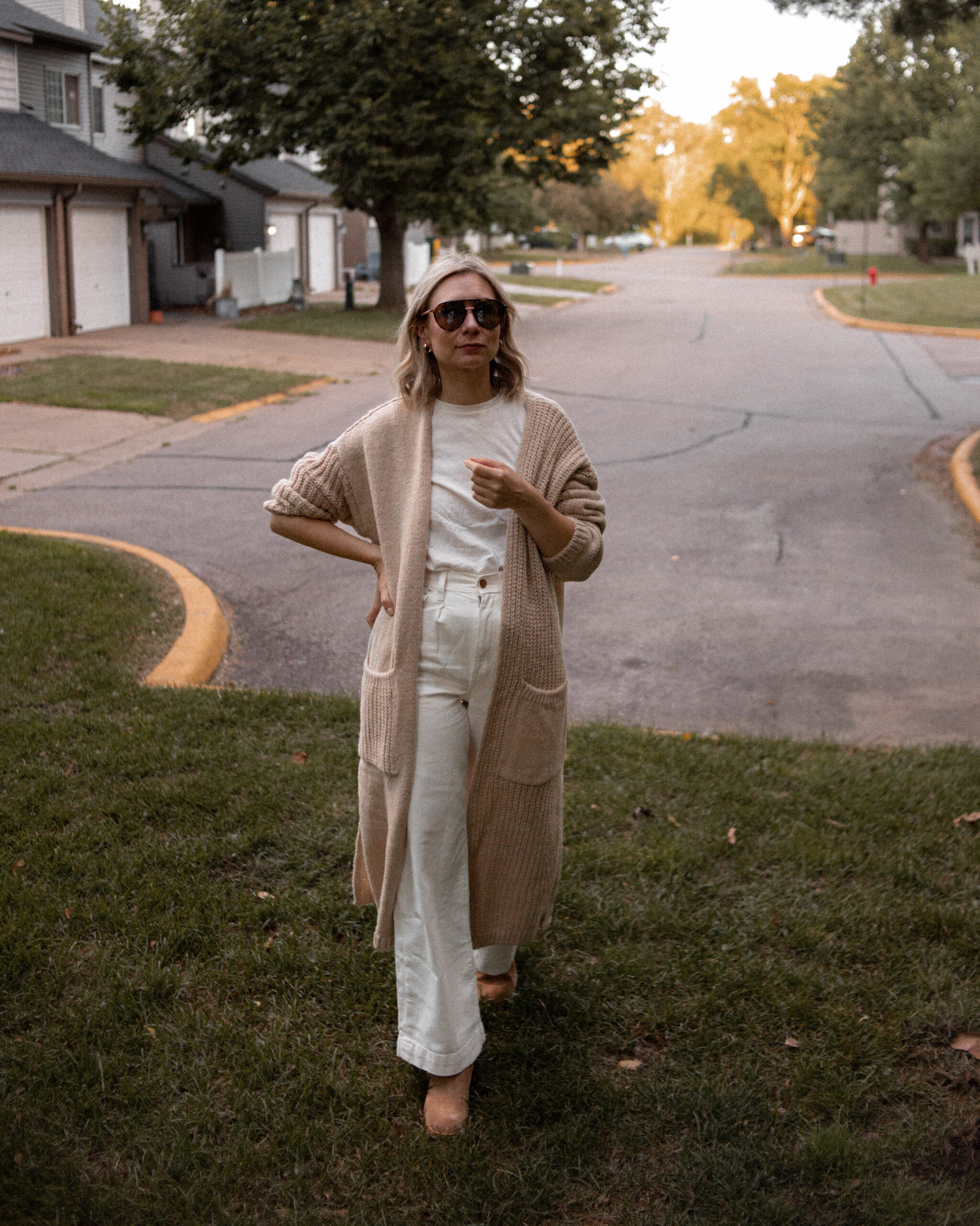 Karin Emily wears a long maxi cardigan and brown suede boots from the Nordstrom Anniversary Sale