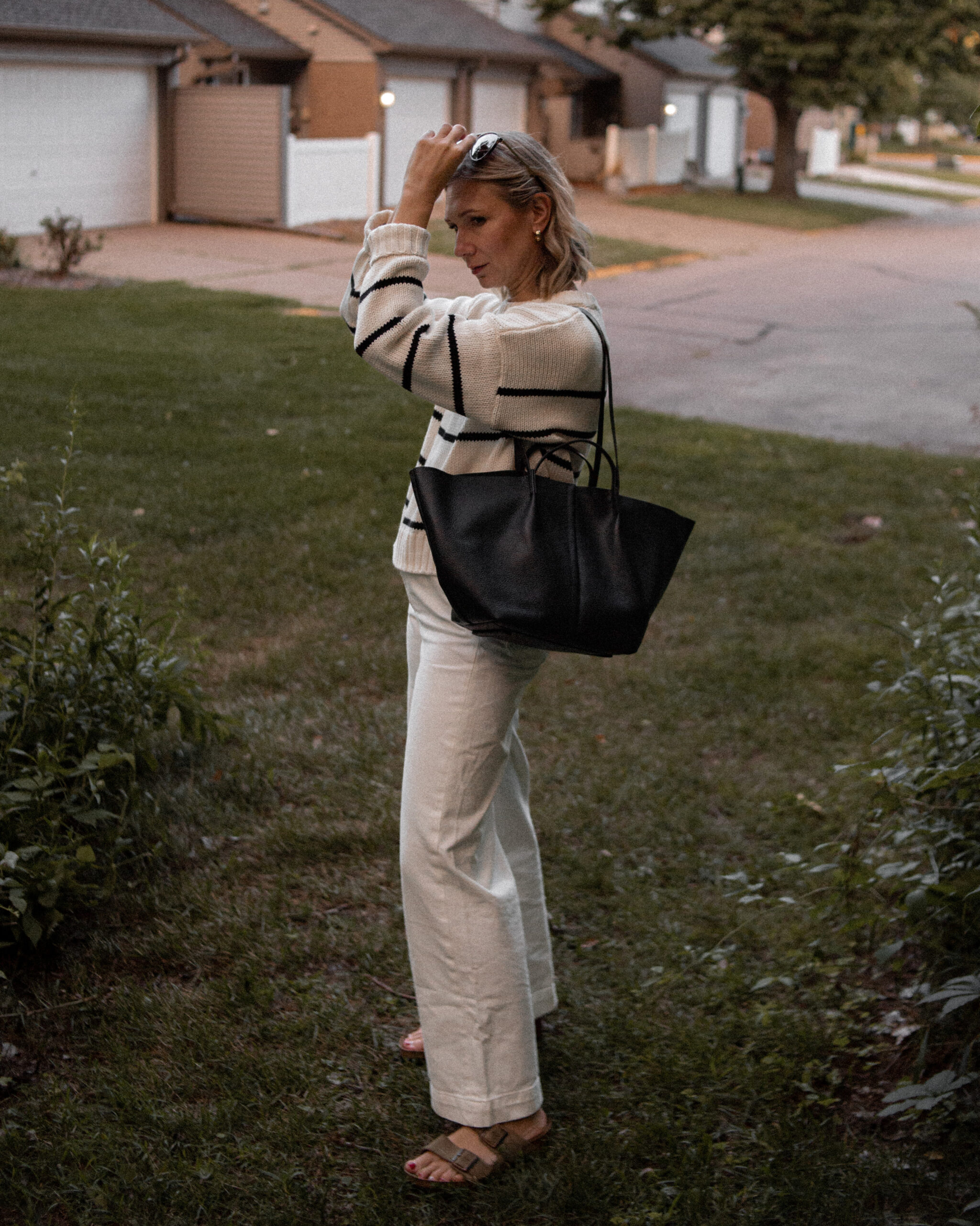 Karin Emily wears a jenni kayne striped sweater, white wide leg pants, birkenstock arizona sandals and a black bag from the Nordstrom Anniversary Sale