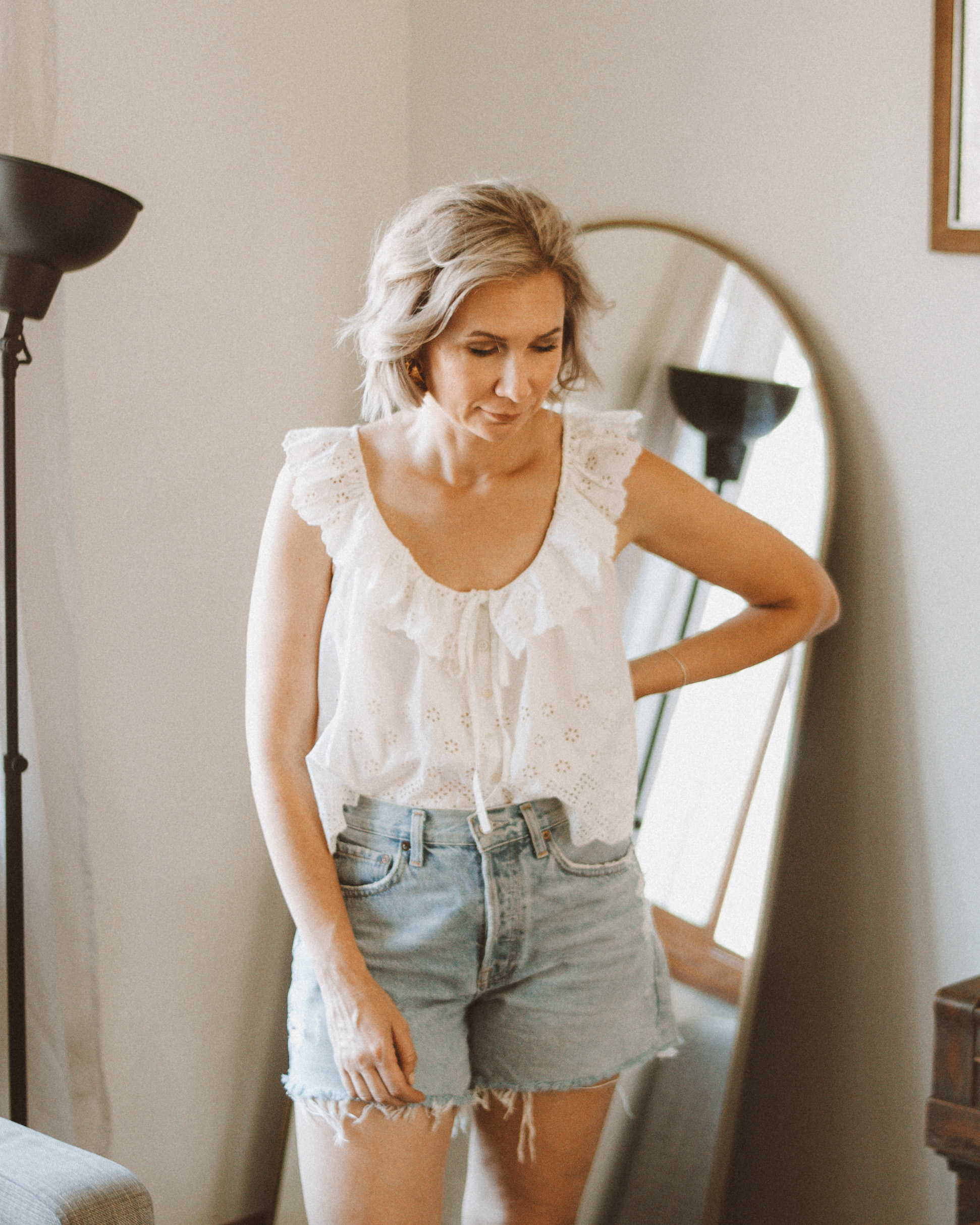 Karin Emily wears a white eyelet tank top and agolde parker shorts for an agolde jean short reviewHi