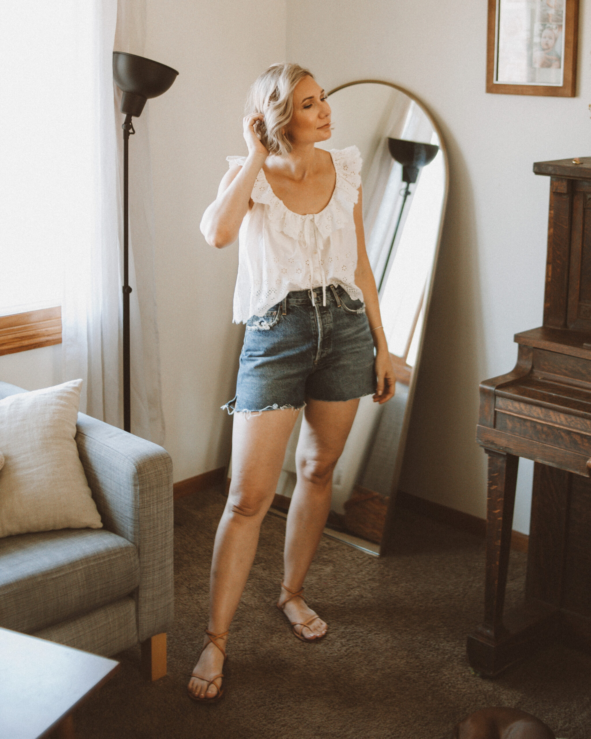 Karin Emily wears a white eyelet tank top and agolde parker shorts for an agolde jean short review