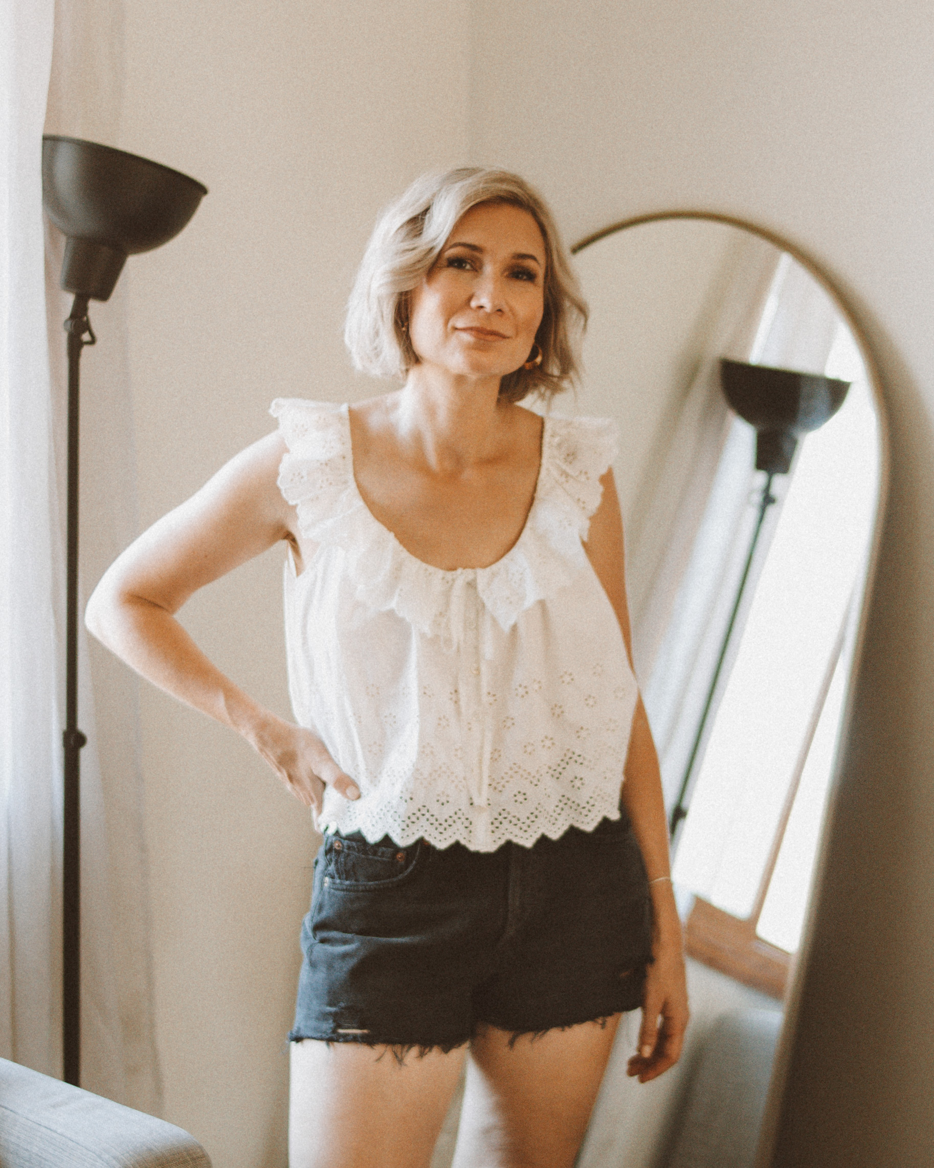 Karin Emily wears a white eyelet tank top and agolde parker shorts for an agolde jean short review