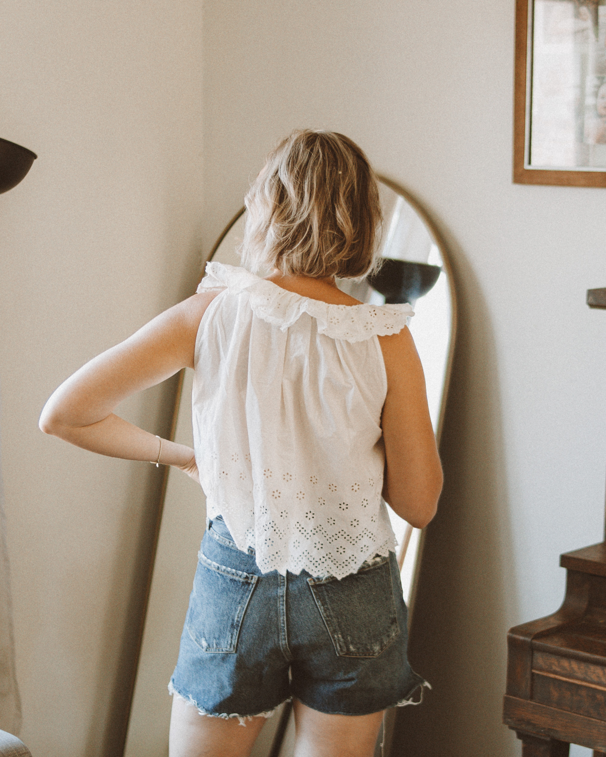 Karin Emily wears a white eyelet tank top and agolde parker shorts for an agolde jean short review