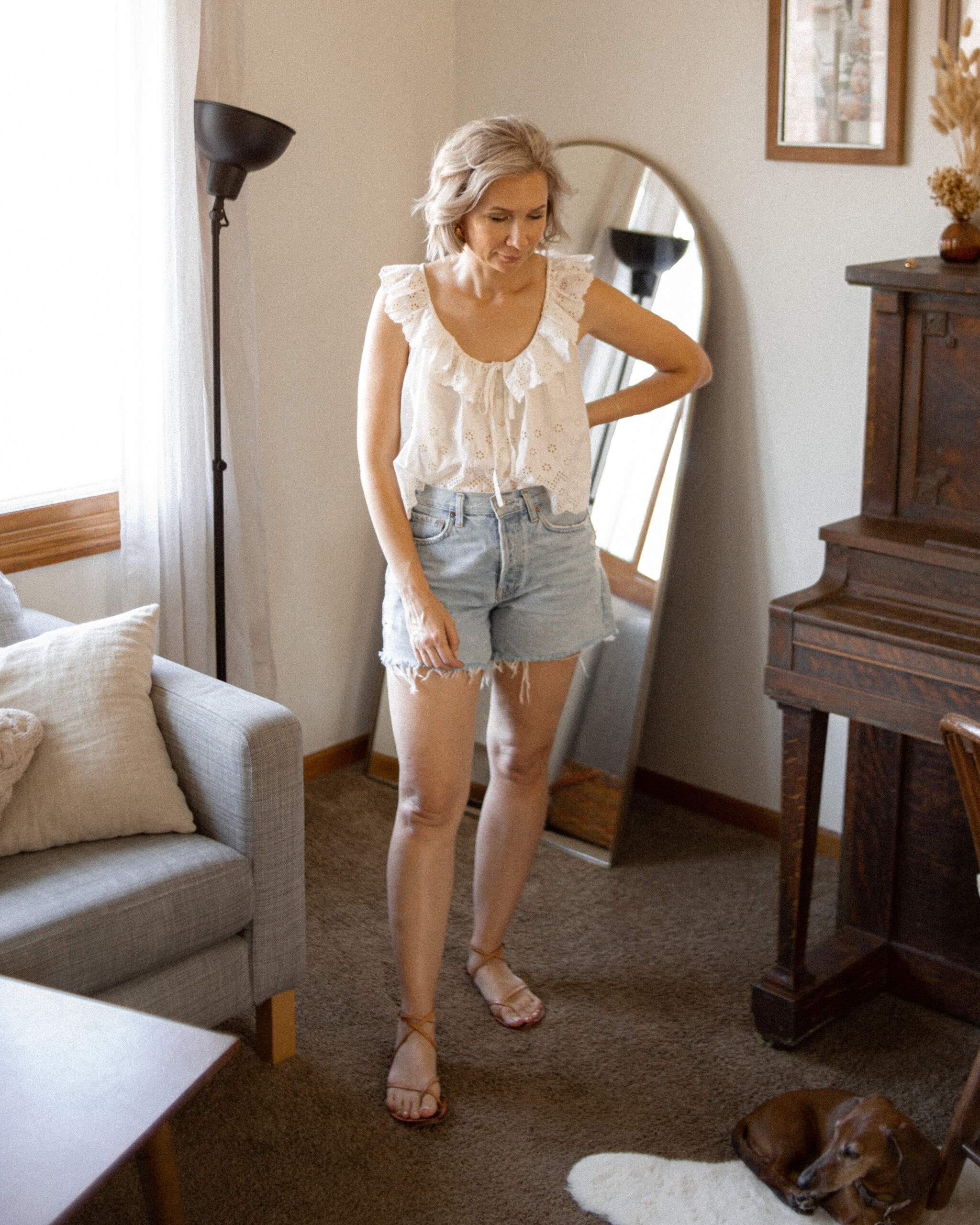 Karin Emily wears a white eyelet tank top and agolde parker long shorts for an agolde jean short review