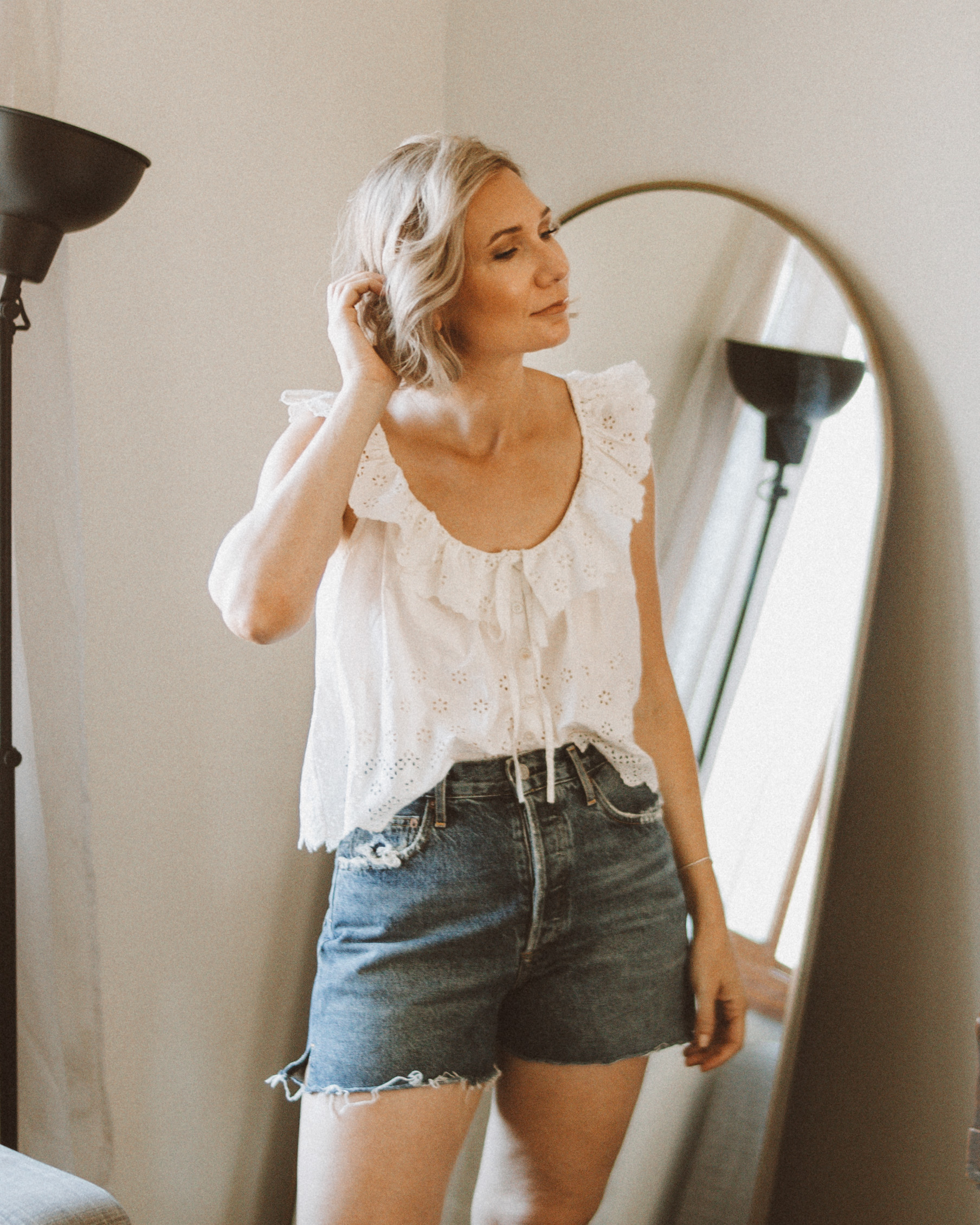 Karin Emily wears a white eyelet tank top and agolde parker shorts for an agolde jean short review