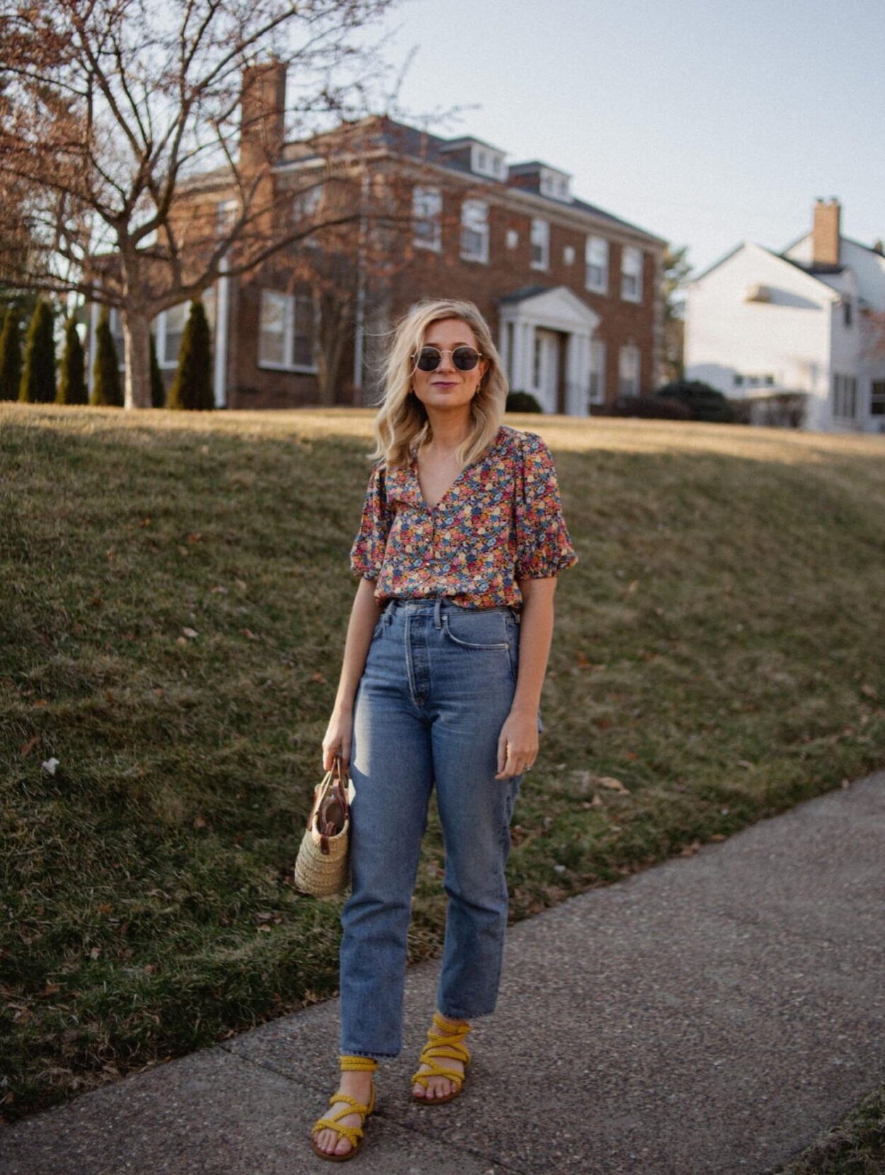 Karin Emily wears a floral top from Sezane and a pair of agolde straight leg jeans