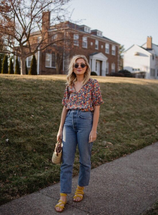 Karin Emily wears a floral top from Sezane and a pair of agolde straight leg jeans