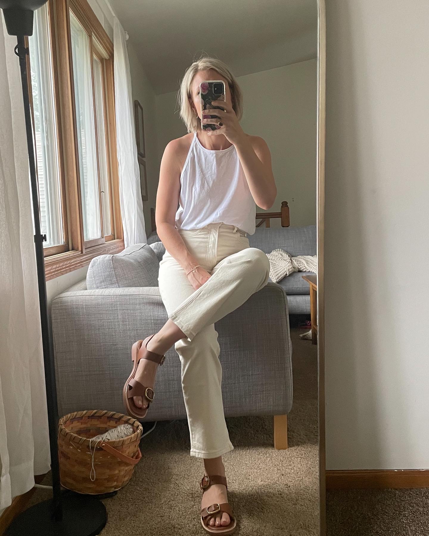 Karin Emily wears a white tank, and the everlane way high jeans