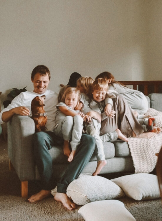 Karin Emily and her family sit on the couch together