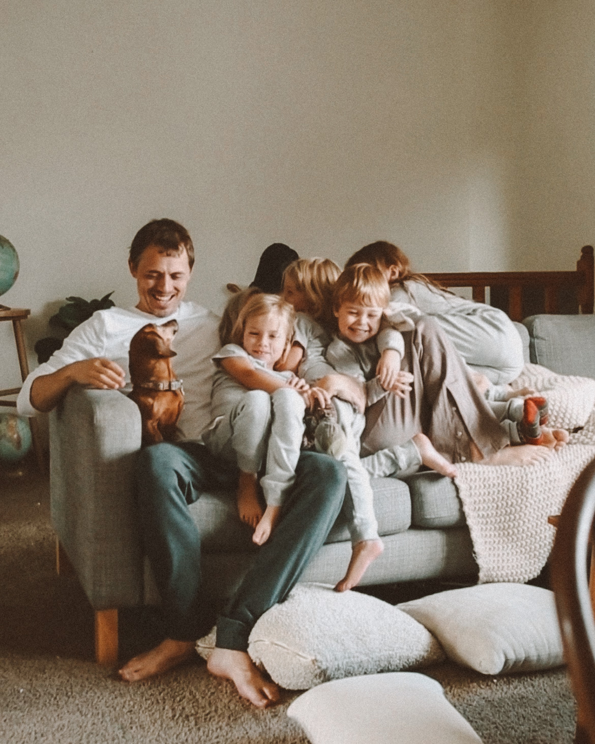 Karin Emily and her family sit on the couch together 