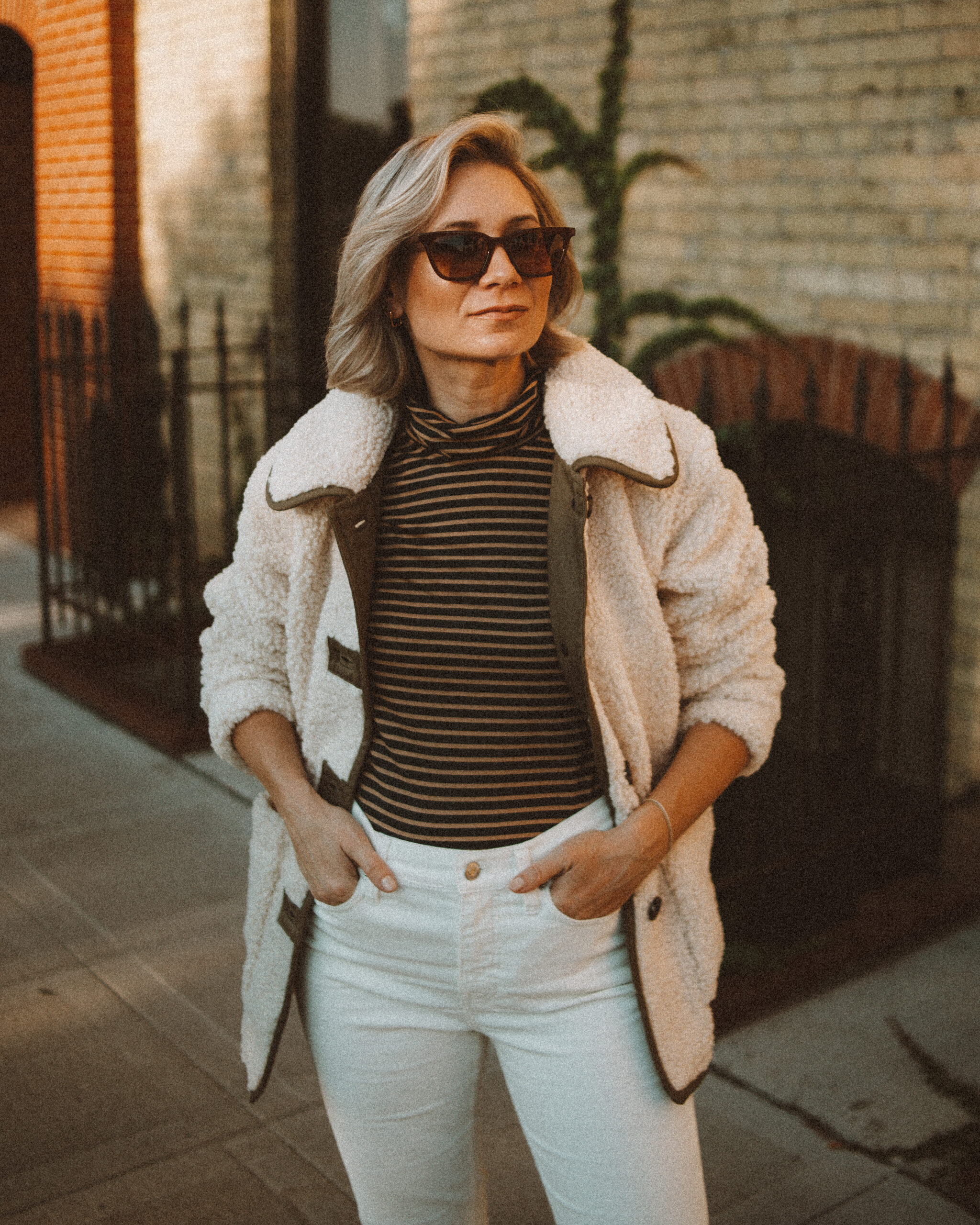 Karin Emily wears the perfect pair of corduroy pants with a striped turtleneck, and sherpa jacket