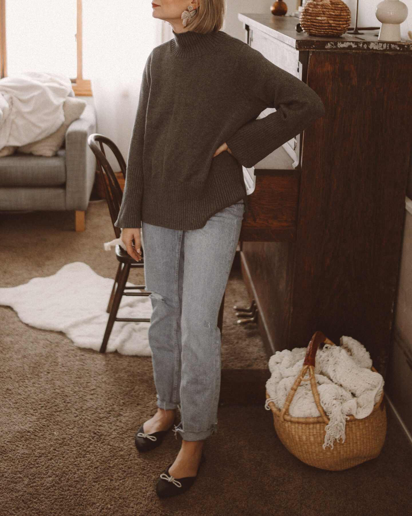 Karin Emily wears one of her  affordable sweaters and pairs of jeans from Walmart with a pair of bow embellished satin flats 