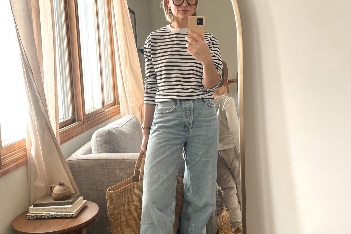 Karin Emily shares a mirror selfie wearing a striped shirt, baggy agolde jeans and two tone flats