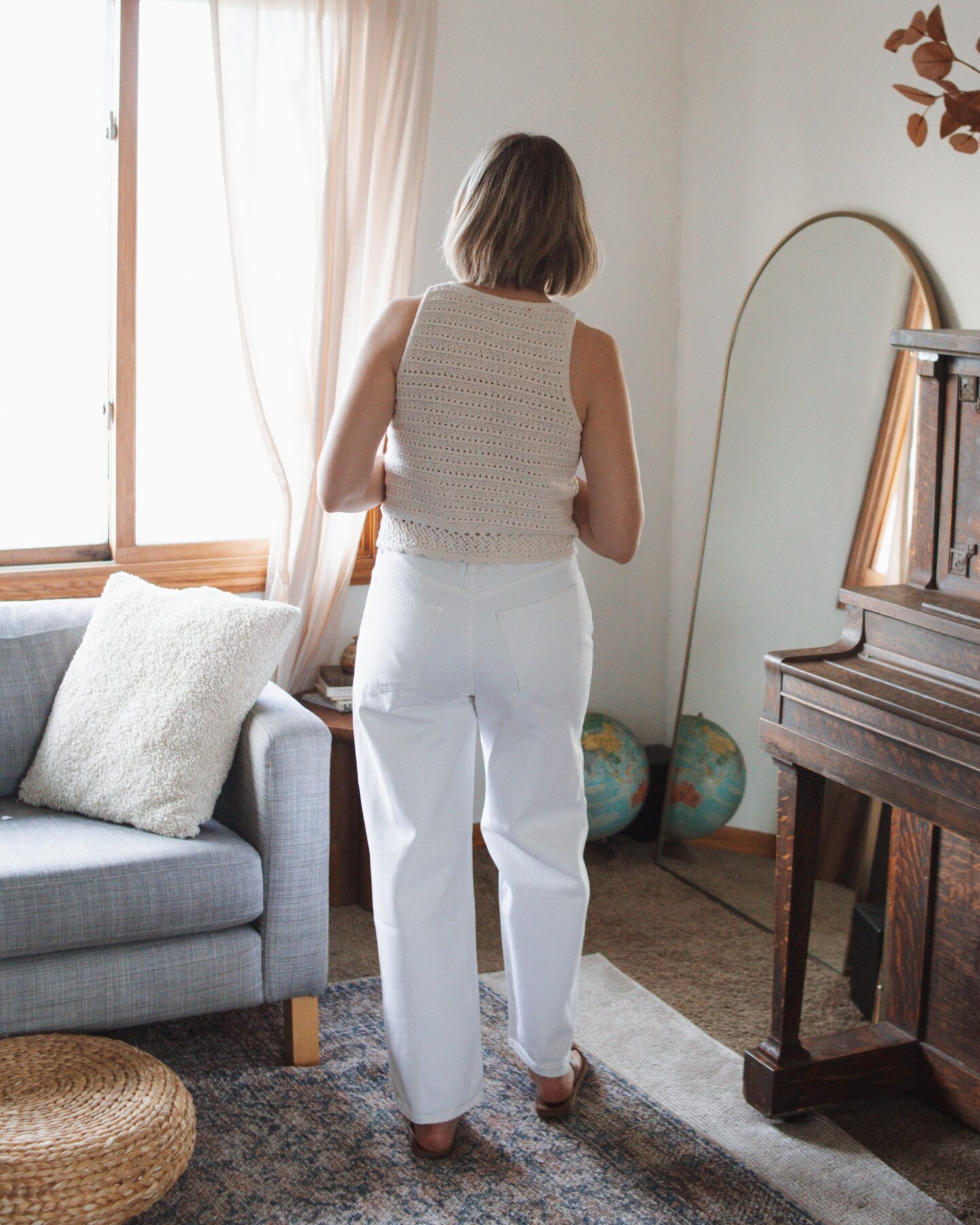 Karin Emily wears the low slung baggy Jean from AGOLDE while standing in her living room