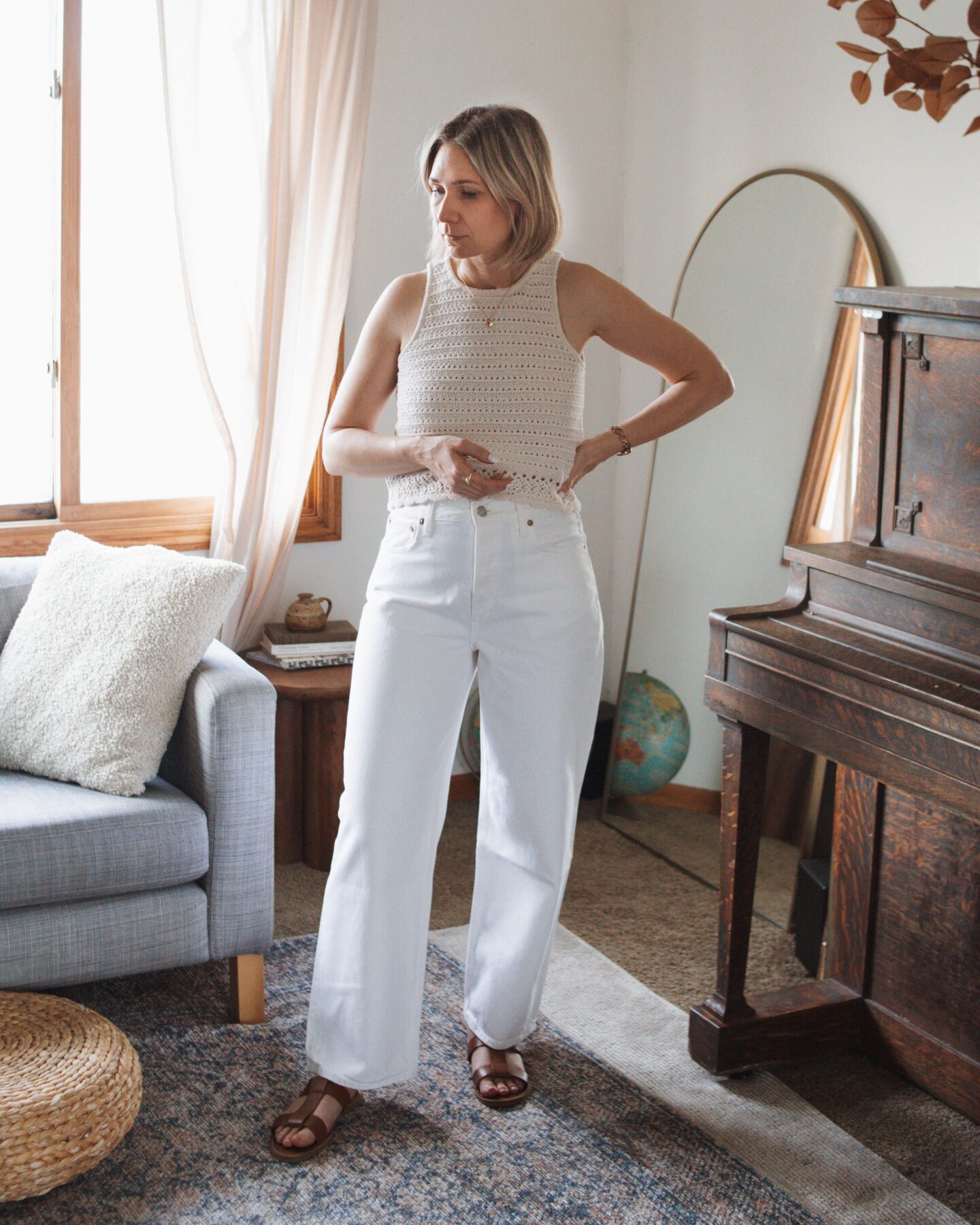 Karin Emily wears the low slung baggy Jean from AGOLDE while standing in her living room 