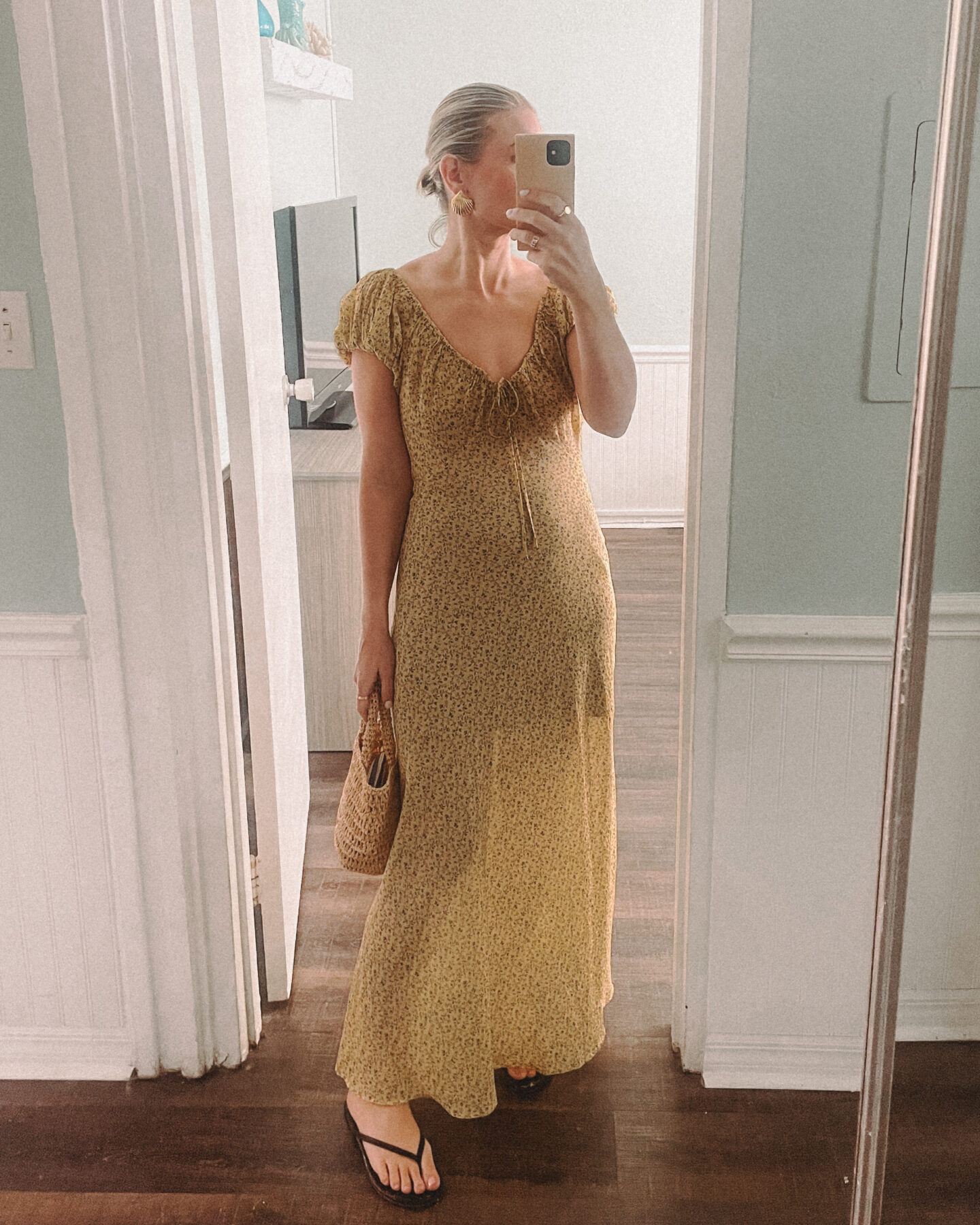 Karin Emily takes a mirror selfie wearing a yellow dress from Doen