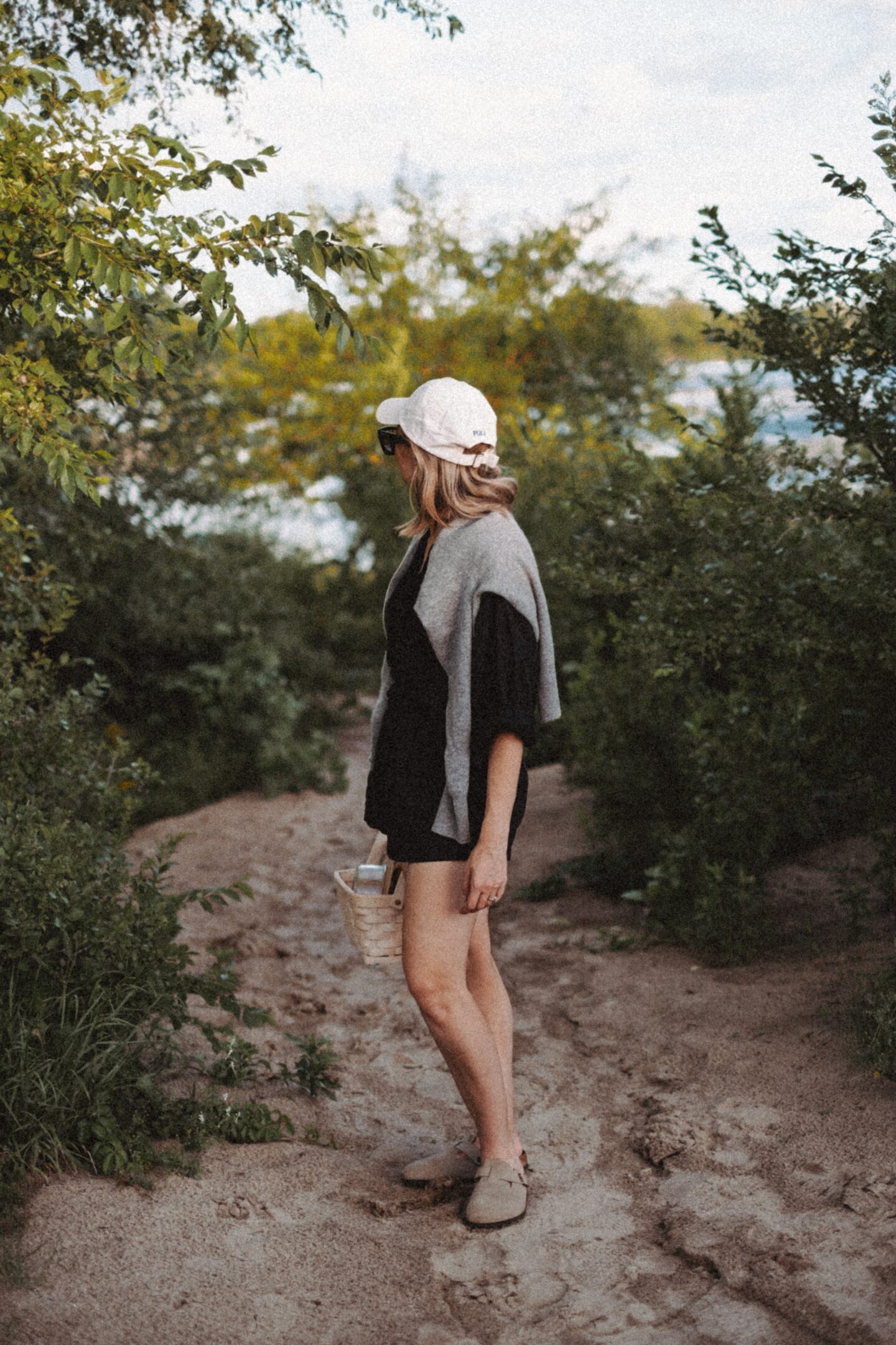 Karin Emily stands with in front of a beach path and wears the Jana top from the pre fall at Doen collection 