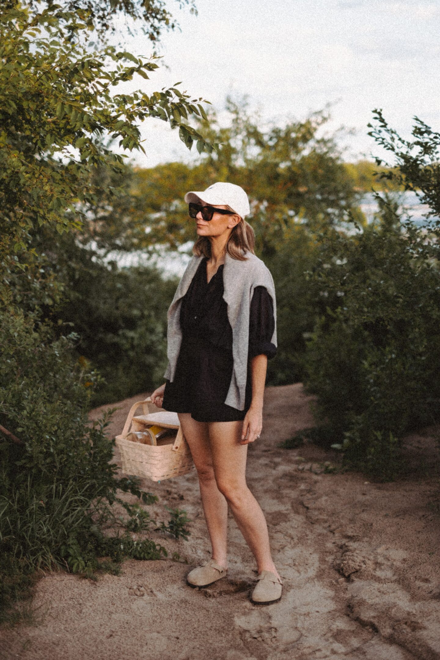 Karin Emily stands with in front of a beach path and wears the Jana top from the pre fall at Doen collection 