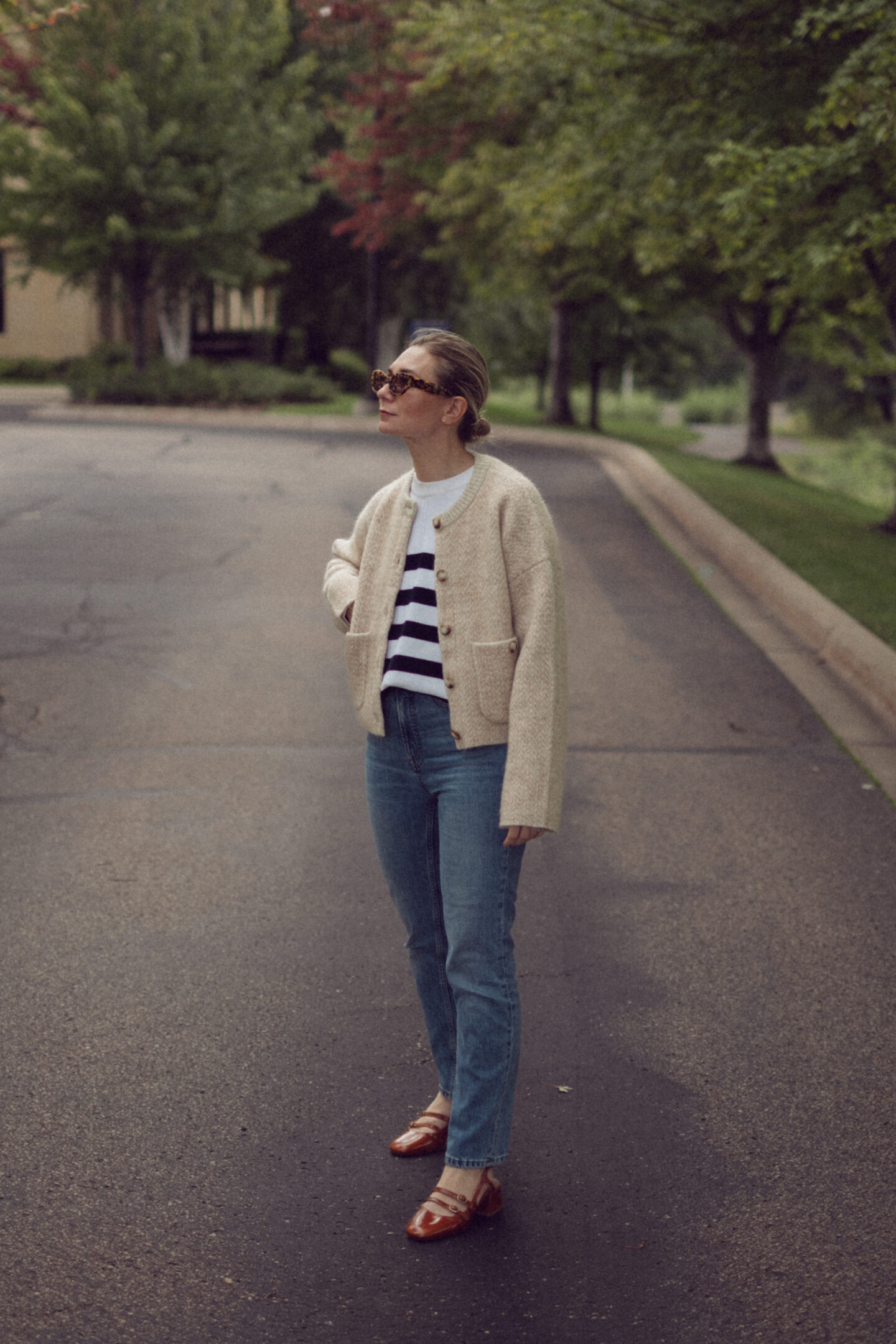 Karin Emily wears an outfit full of new Sezane pieces for fall while standing in the driveway outside of an office building