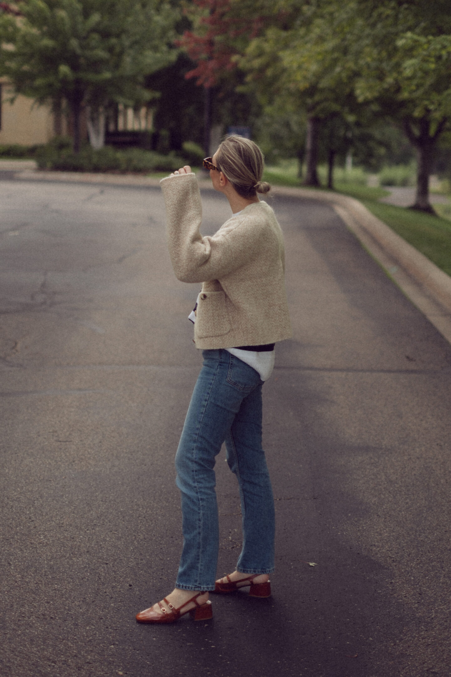 Karin Emily wears an outfit full of new Sezane pieces for fall while standing in the driveway outside of an office building