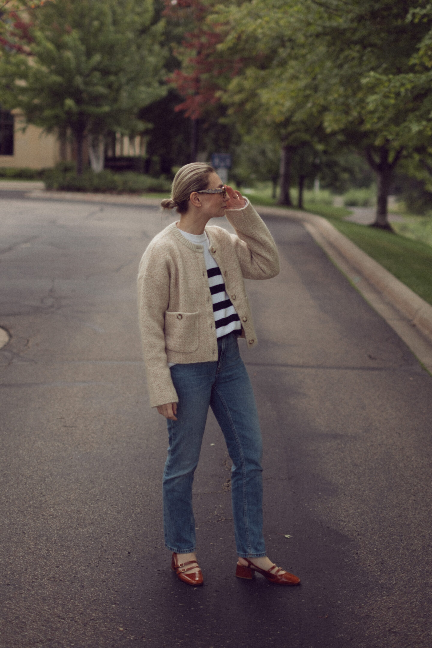 Karin Emily wears an outfit full of new Sezane pieces for fall while standing in the driveway outside of an office building