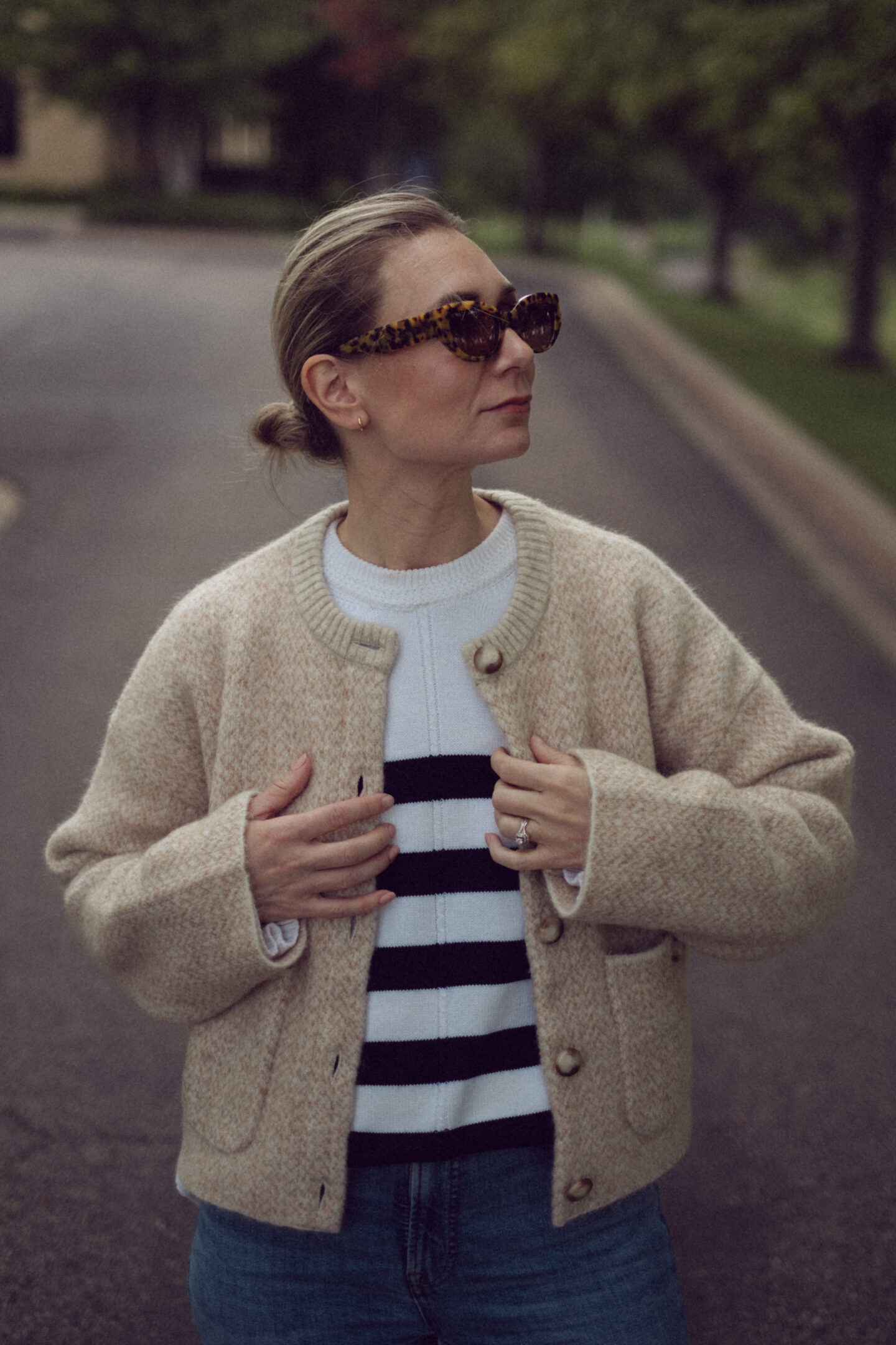 Karin Emily wears an outfit full of new Sezane pieces for fall while standing in the driveway outside of an office building