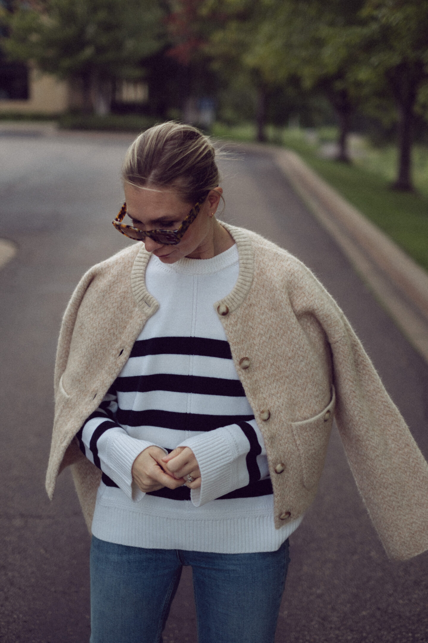 Karin Emily wears an outfit full of new Sezane pieces for fall while standing in the driveway outside of an office building