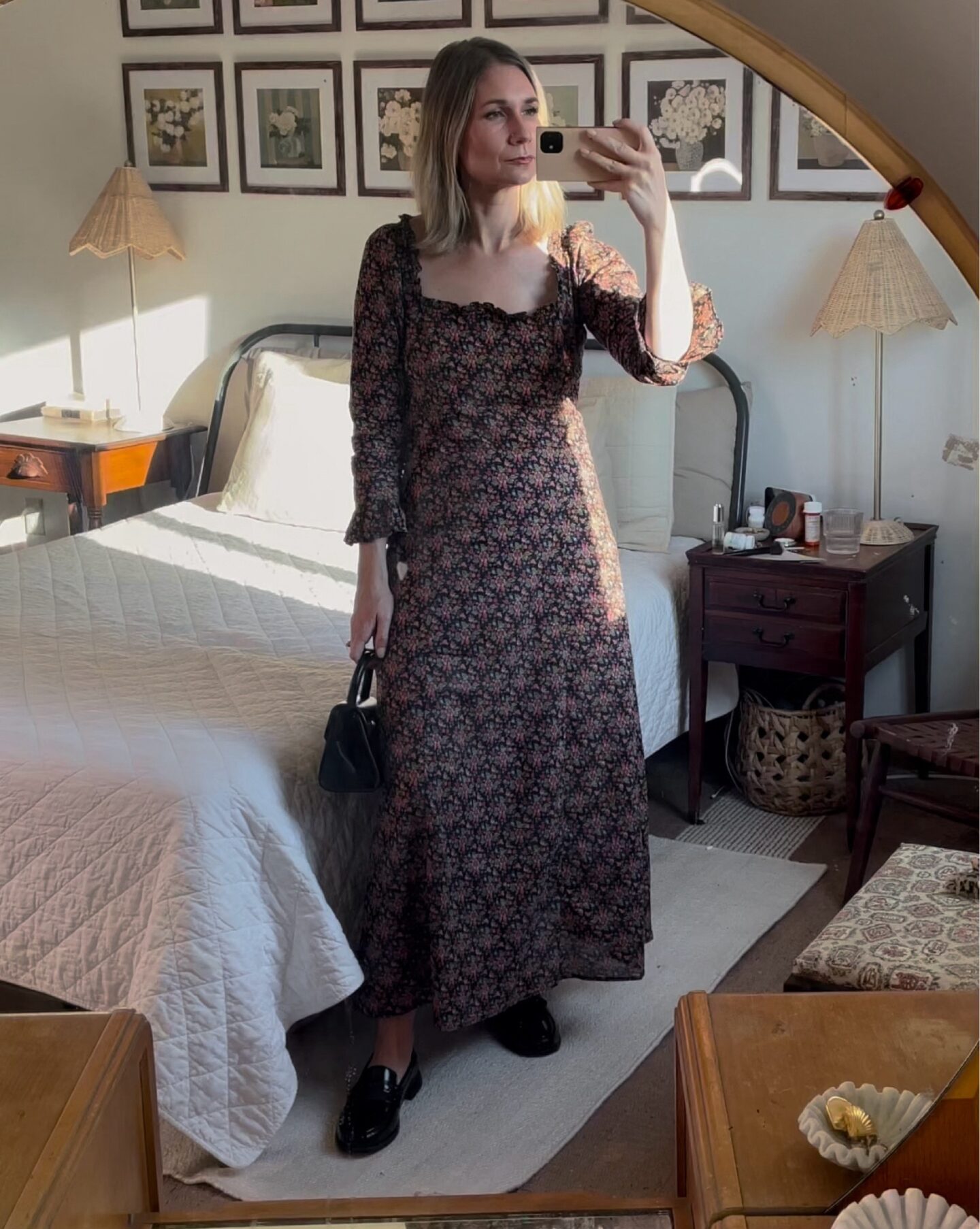 Karin Emily wears a long floral maxi dress with ruffled arms and black loafers