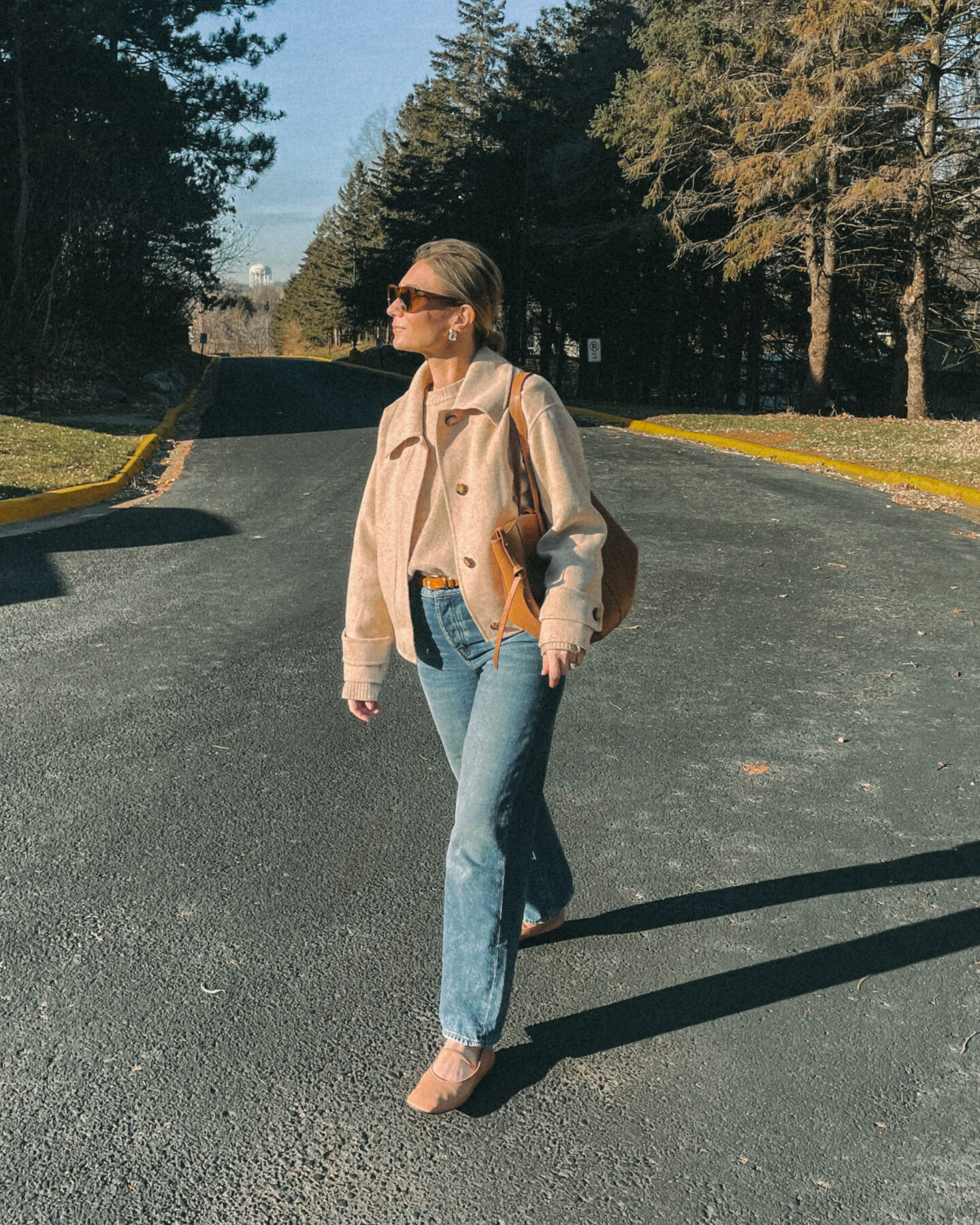 Karin Emily wears a beige sweater 