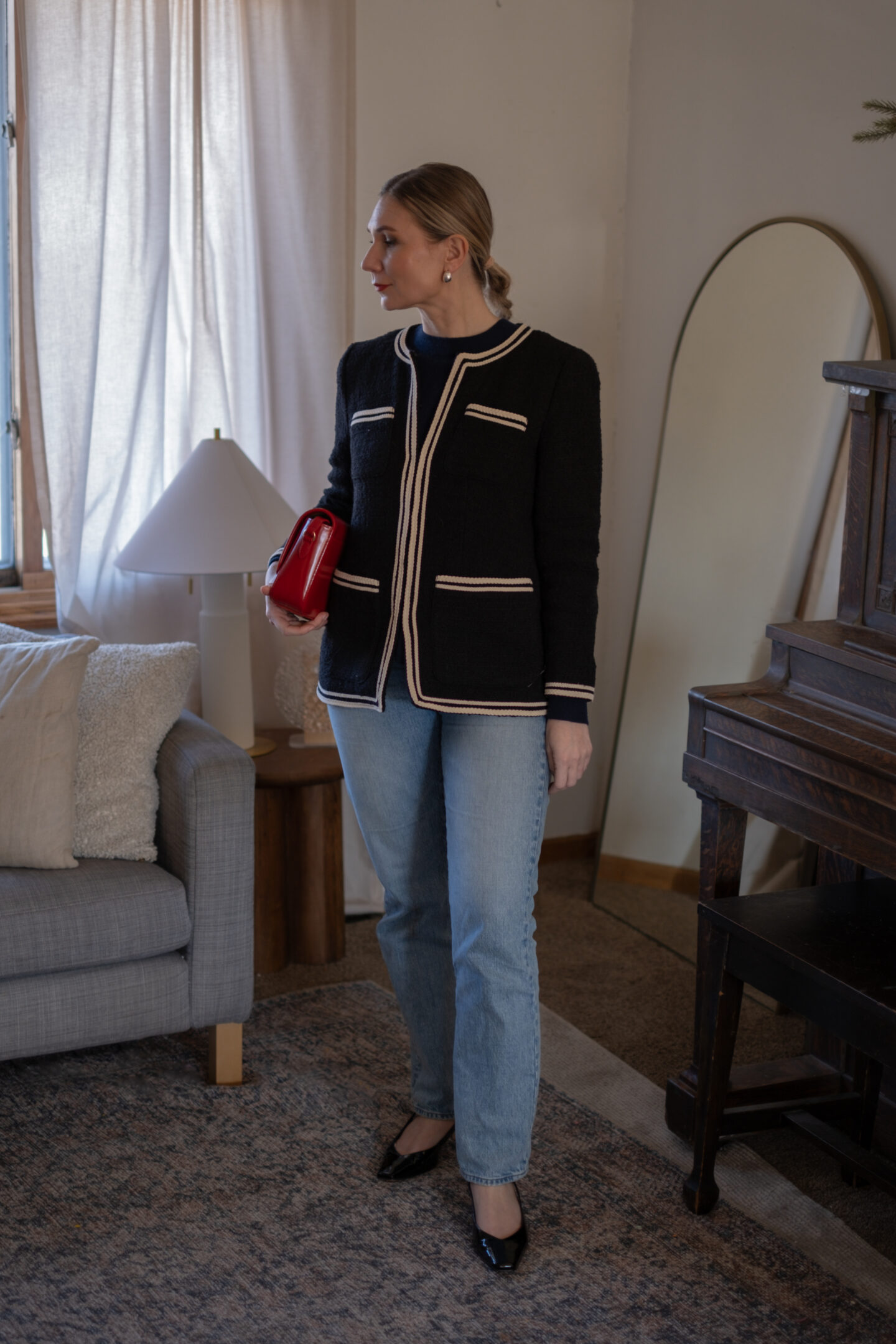 Karin Emily looks date night ready with a wool lady jacket, navy cashmere sweater, jeans and a pair of black patent heels 