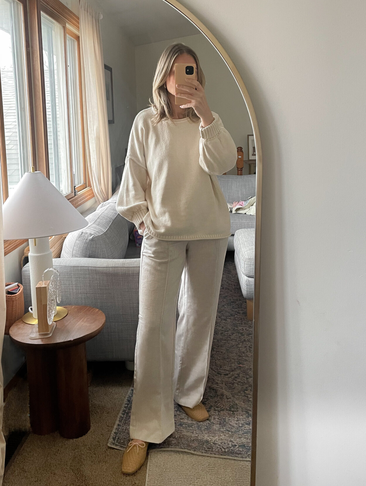 Karen Emily wears an oversized cream sweater with a pair of oatmeal colored pants with a pair of woven Jada flats from Freda Salvador for a recent post about recent outfits