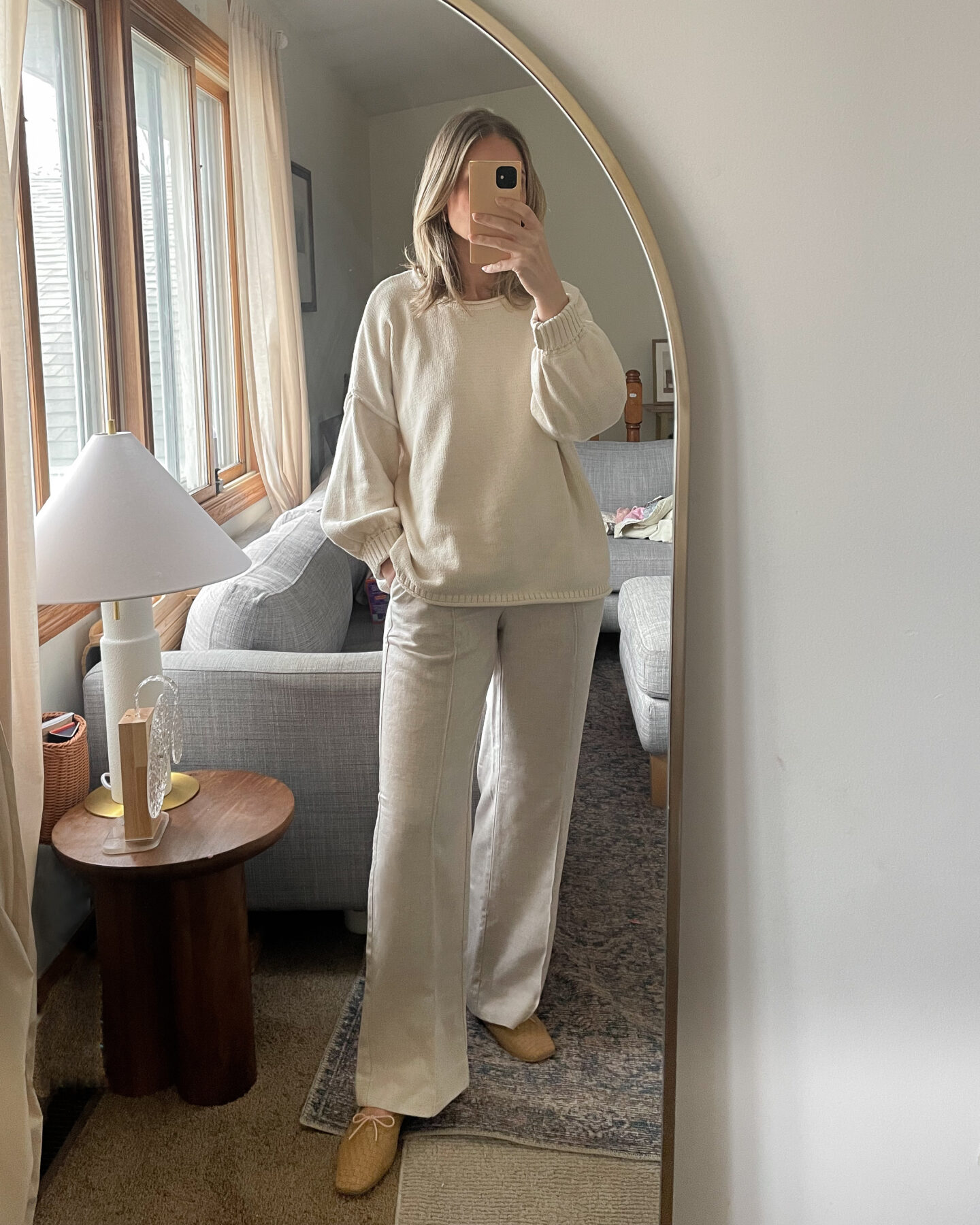 Karen Emily personal style wears an oversized cream sweater with a pair of oatmeal colored pants with a pair of woven Jada flats from Freda Salvador for a recent post about recent outfits