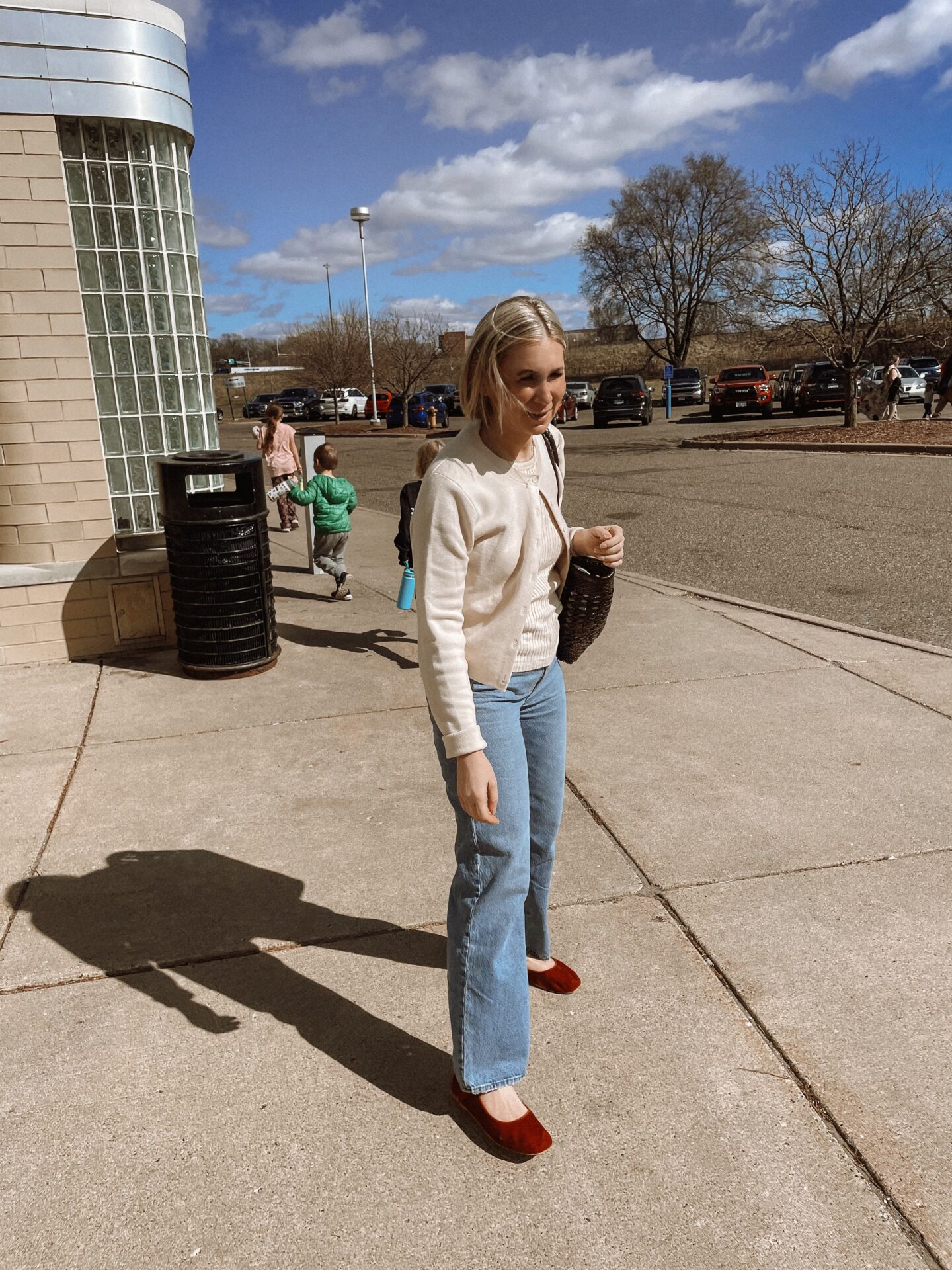 Karin Emily shares her daily look while standing in front of an AMC movie theatre 