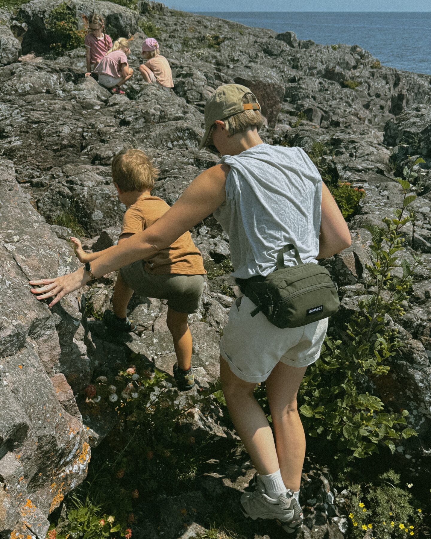 Karin Emily hikes with her kids on some cliffs in North Shore Minnesota wearing one of her athleisure summer uniforms 