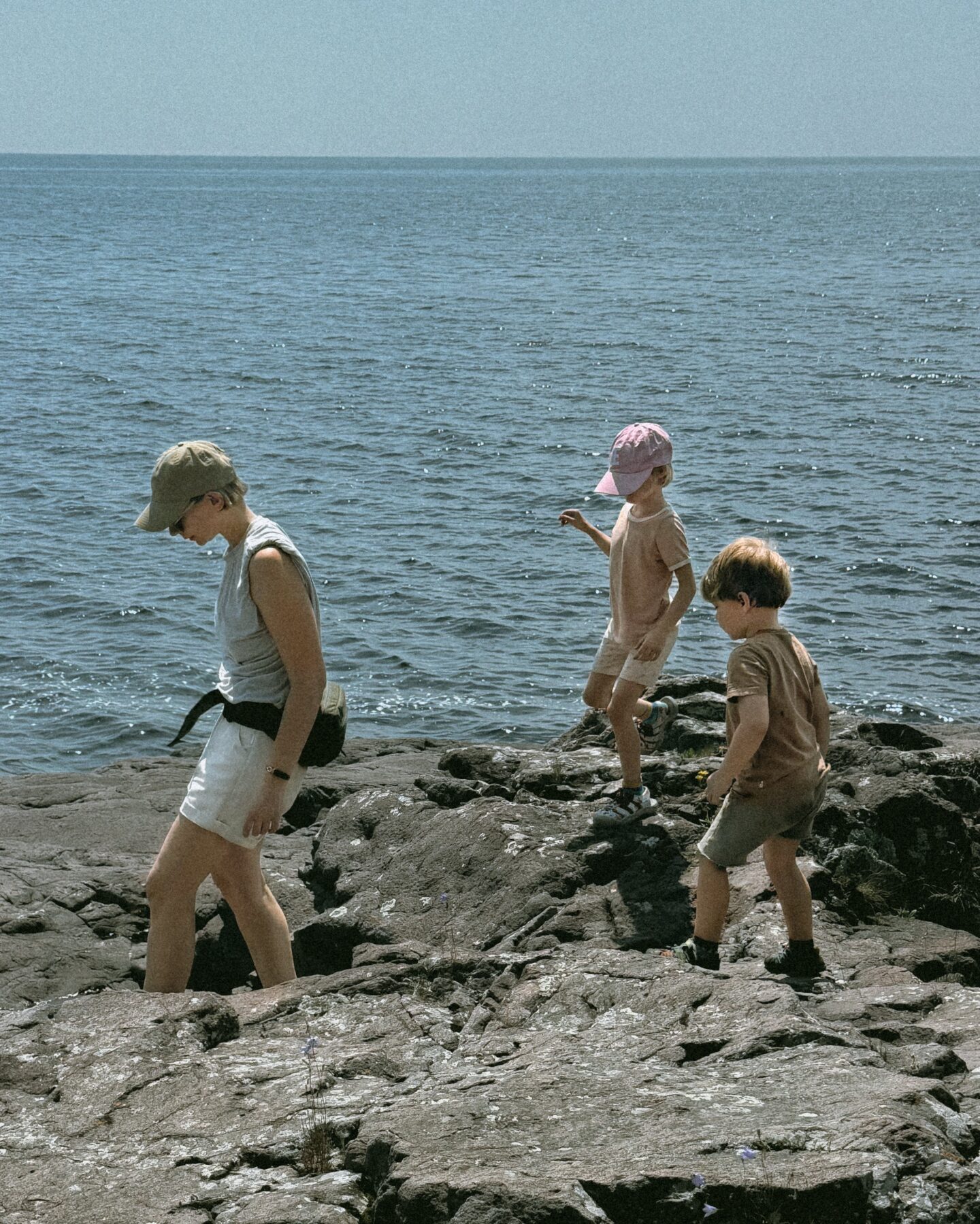 Karin Emily hikes with her kids on some cliffs in North Shore Minnesota wearing one of her athleisure summer uniforms 