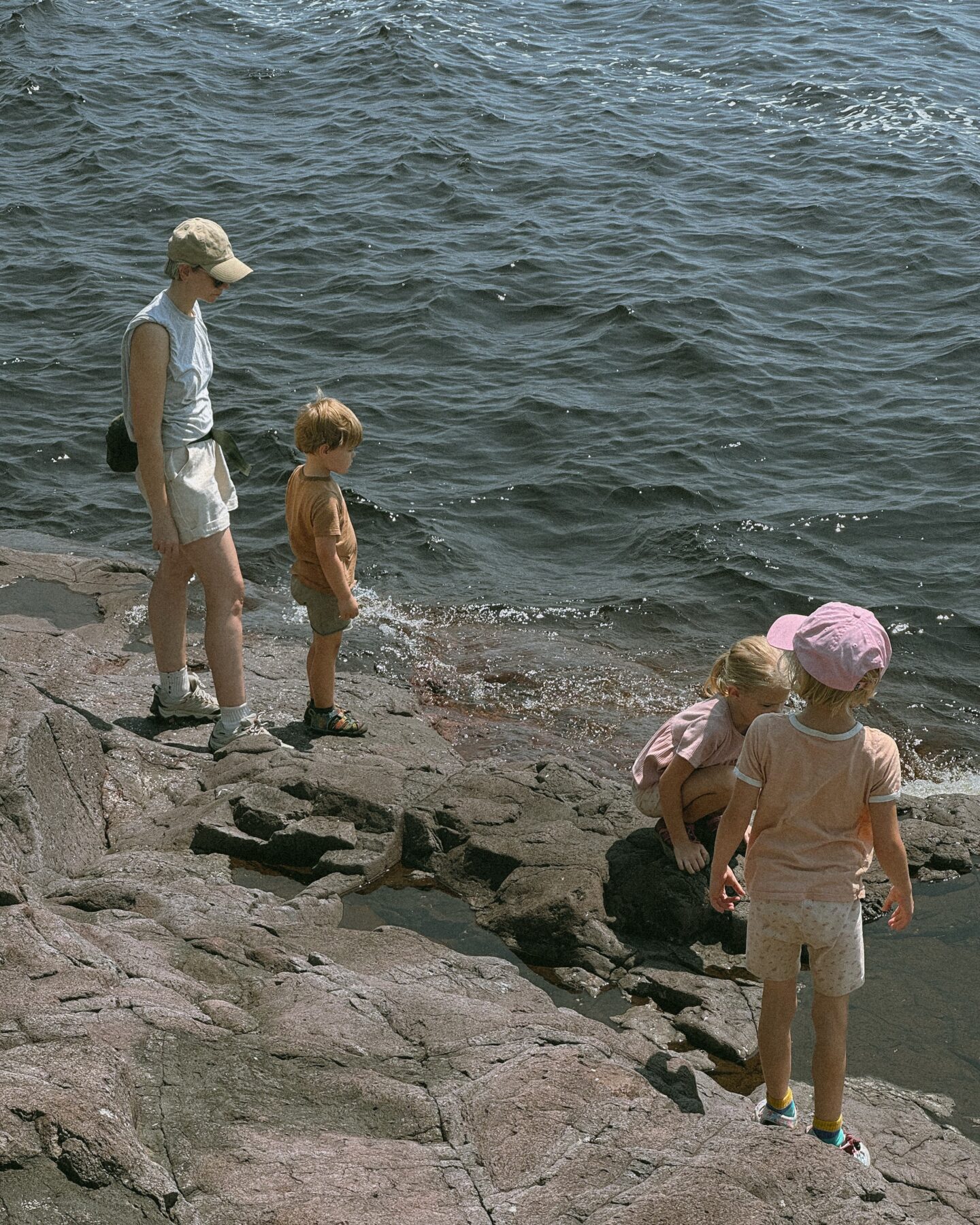 Karin Emily hikes with her kids on some cliffs in North Shore Minnesota wearing one of her athleisure summer uniforms 