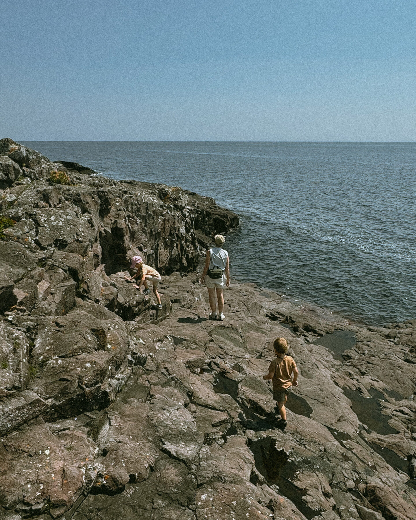 Karin Emily hikes with her kids on some cliffs in North Shore Minnesota wearing one of her athleisure summer uniforms 