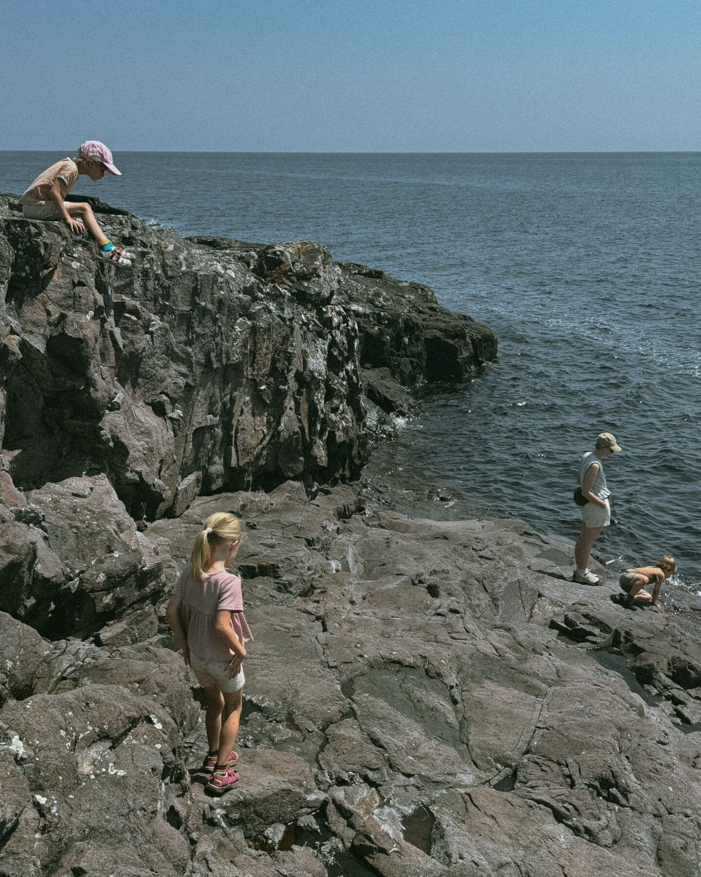 Karin Emily hikes with her kids on some cliffs in North Shore Minnesota wearing one of her athleisure summer uniforms 